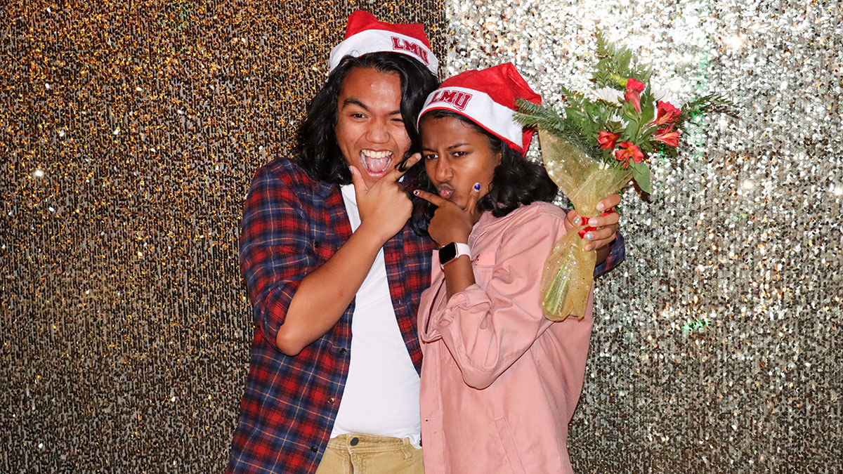 Two students making funny faces in a photo booth