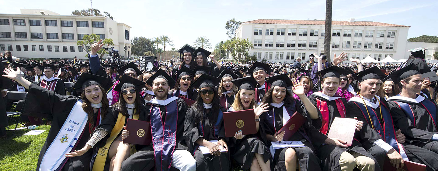 Graduates excitedly cheering in their seats as commencement begins