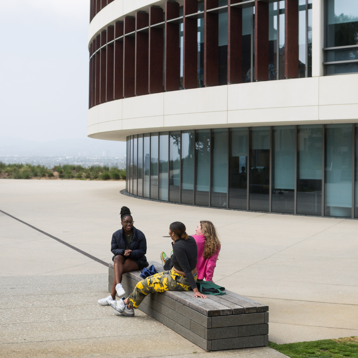 Students sitting outside the William H. Hannon Library