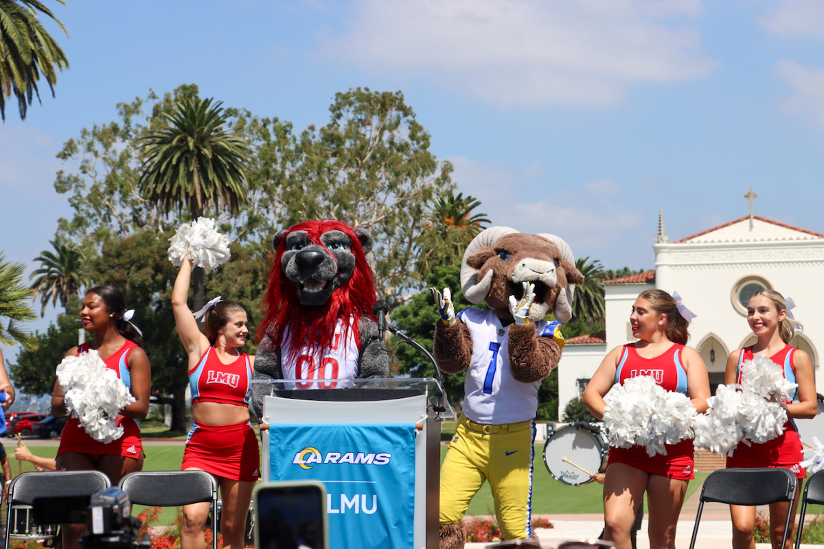 LMU cheerleaders on stage with Iggy the Lion and Rams mascot Rampage